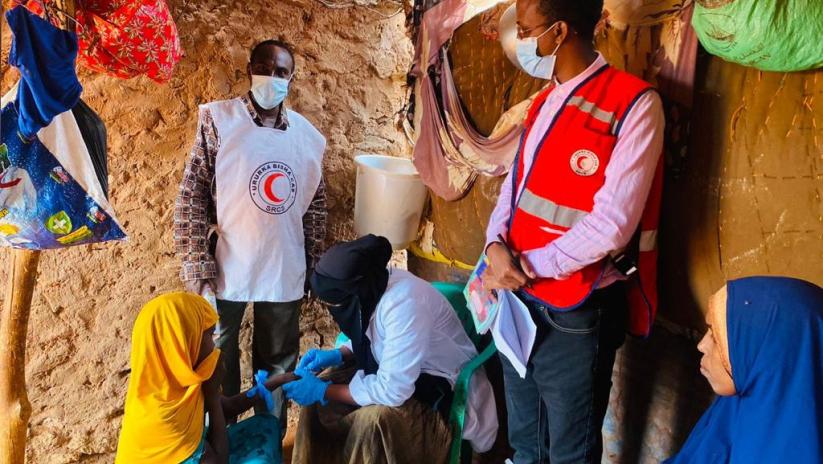 SRCS CBS team and laboratory technician collecting blood samples from the children showing symptoms of fever and rash.