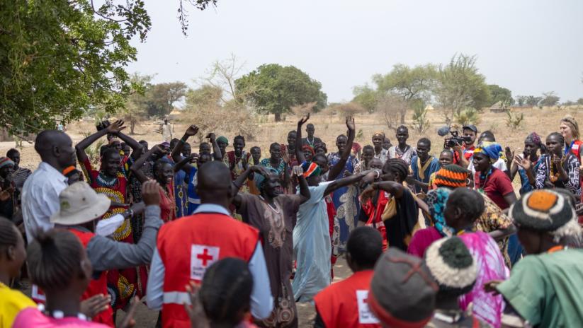 A community in Aweil, South Sudan, dances following the construction of a new borehole through the Programmatic Partnership.